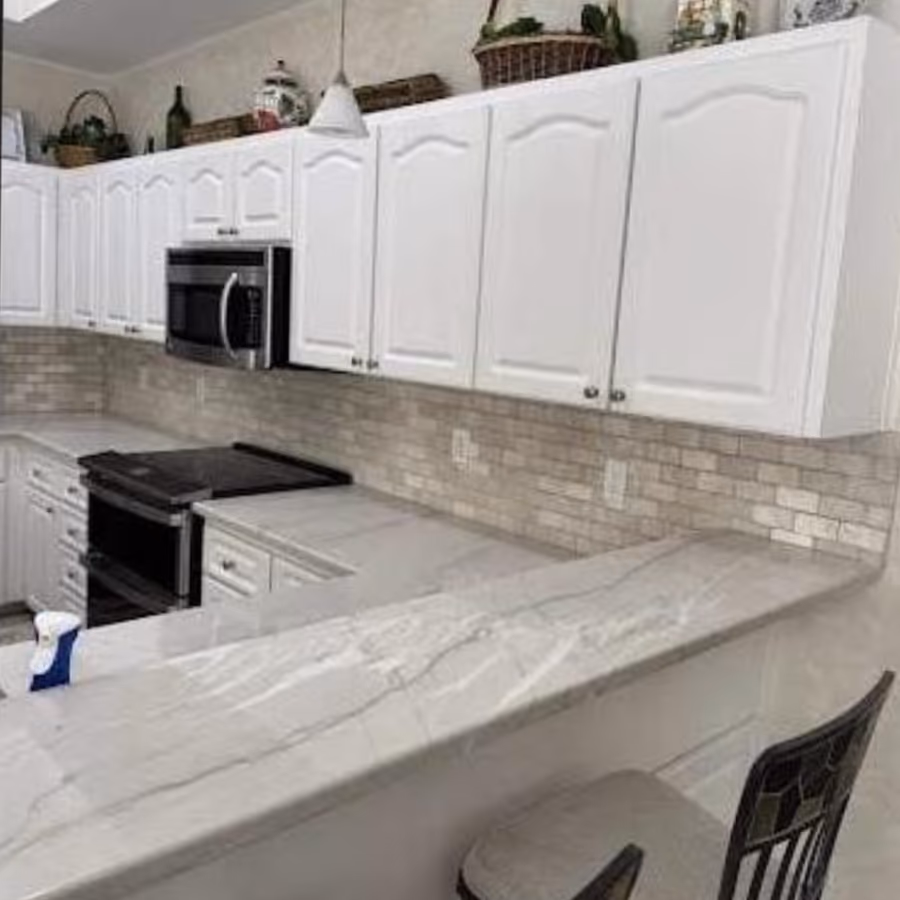 Kitchen with new stone tile backsplash and counters finished by The Handyman Company