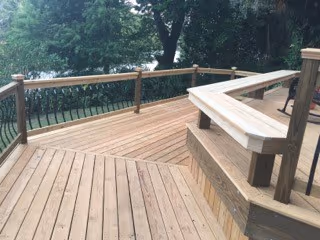 New wood deck with built-in bench seating and railings