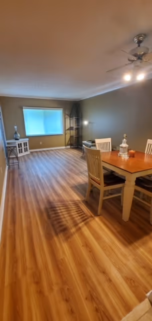 Same living room with new plank flooring and fresh paint