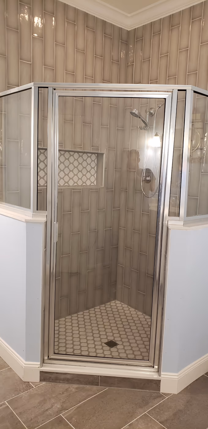 Rebuilt shower with new wall tile and a mosaic accent niche